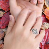 Close up of White Opal Celestial Sun Moon Ring on model's finger